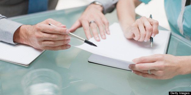 Businessman and businesswoman reviewing paperwork