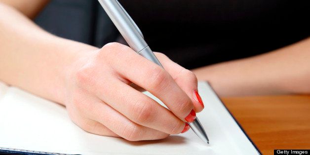 Young woman writing in office