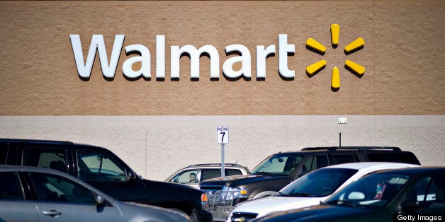 Vehicles sit in the parking lot outside a Wal-Mart store in East Peoria, Illinois, U.S., on Wednesday, Feb. 20, 2013. Wal-Mart Stores Inc., the world?s largest retailer, projected first-quarter profit that trailed analysts? estimates as an increase in the payroll tax and delayed refunds curtail spending by its lower-income shoppers. Photographer: Daniel Acker/Bloomberg via Getty Images