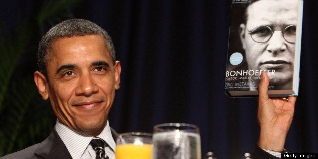 WASHINGTON, DC - FEBRUARY 2: (AFP OUT) U.S. President Barack Obama holds up a book given to him by author Eric Metaxas, who was the keynote speaker at the National Prayer Breakfast February 2, 2012 in Washington, DC. Obama also spoke, defending his economic policies in an echo of his recent State of the Union address. (Photo by Chris Kleponis-Pool/Getty Images)