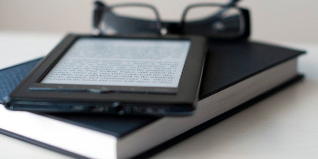 E-Reader and book with reading glasses.