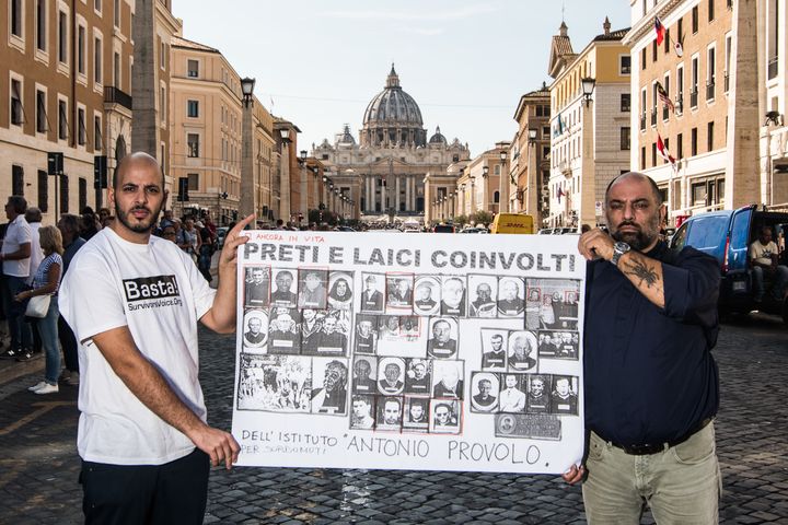 Protestors in Rome hold a banner with pictures of priests accused of abusing hearing impaired children at the Antonio Provolo Institute. 