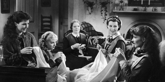 American actresses Jean Parker, Joan Bennett (1910 - 1990), Spring Byington (1886 - 1971), Frances Dee (1909 - 2004), and Katharine Hepburn (1907 - 2003) sew in character on set as the March women in a still from an adaptation of Louisa May Alcott's book 'Little Women' directed by George Cukor, 1933. (Photo by RKO Pictures/Courtesy of Getty Images)