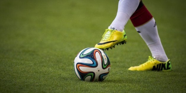 A German player warms up with the Brazuca, the official football of the 2014 World Cup, prior to a friendly football match between Germany and Poland at the Imtech arena in Hamburg on May 13, 2014. AFP PHOTO / ODD ANDERSEN (Photo credit should read ODD ANDERSEN/AFP/Getty Images)