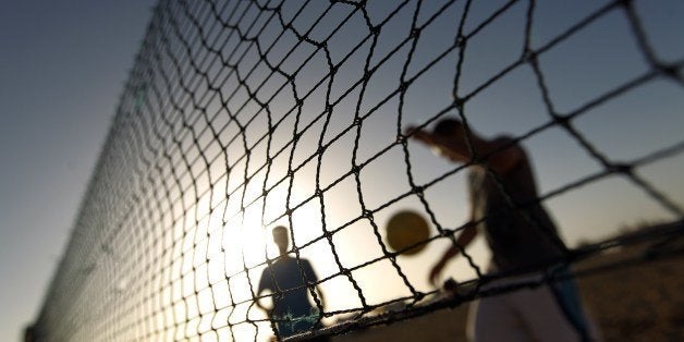 Libyans play footvolley on a beach on June 27, 2014 in the eastern city of Benghazi. Footvolley is like beach volleyball except that players are not allowed to use their hands and a football replaces the volleyball. AFP PHOTO / ABDULLAH DOMA (Photo credit should read ABDULLAH DOMA/AFP/Getty Images)