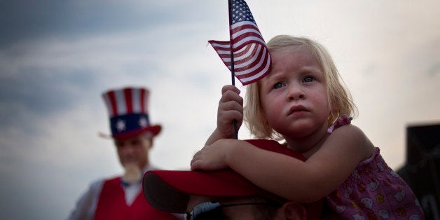 SOUTH RIDING, VA - JULY 3: With Uncle Sam to her right, Finley Zaiko, 2, watches Republican US Senate candidate and former Senator George Allen as he campaigns in South Riding, Virginia on Tuesday, July 3, 2012. (Photo by Melina Mara/The Washington Post via Getty Images) 