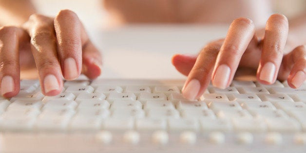 Cape Verdean woman typing on keyboard