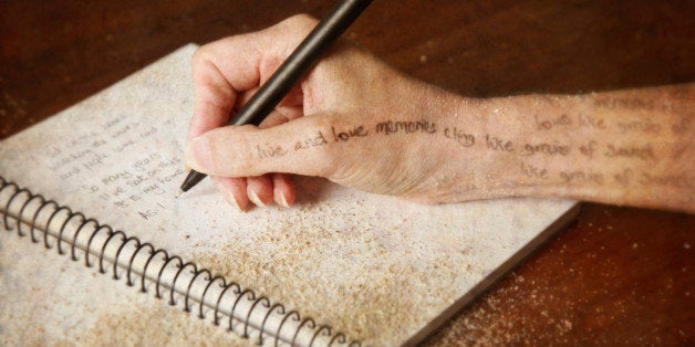 Woman writing poetry in her journal - conceptual image of the creative process