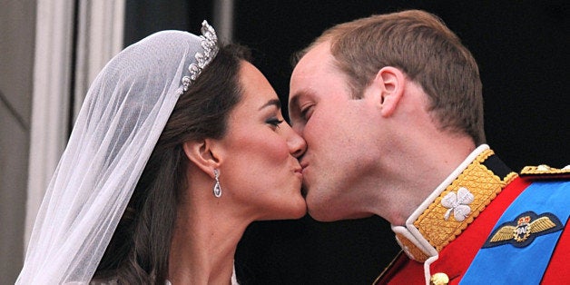 Prince William and his wife Kate Middleton, Duchess of Cambridge, kiss on the balcony of Buckingham Palace in London, following their wedding on April 29, 2011. AFP PHOTO / WPA POOL / JOHN STILLWELL (Photo credit should read JOHN STILLWELL/AFP/Getty Images)