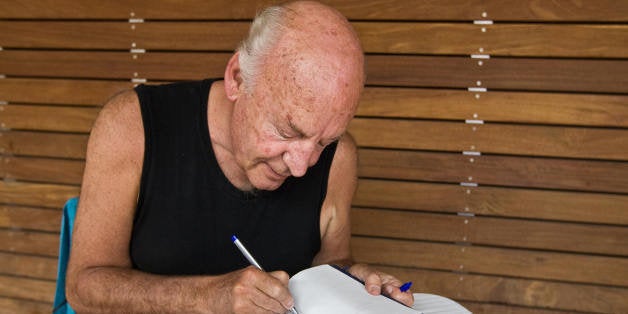 (FILE) Picture taken on April 3, 2009 of Uruguayan writer Eduardo Galeano autographing an edition of 'The Open Veins of Latin