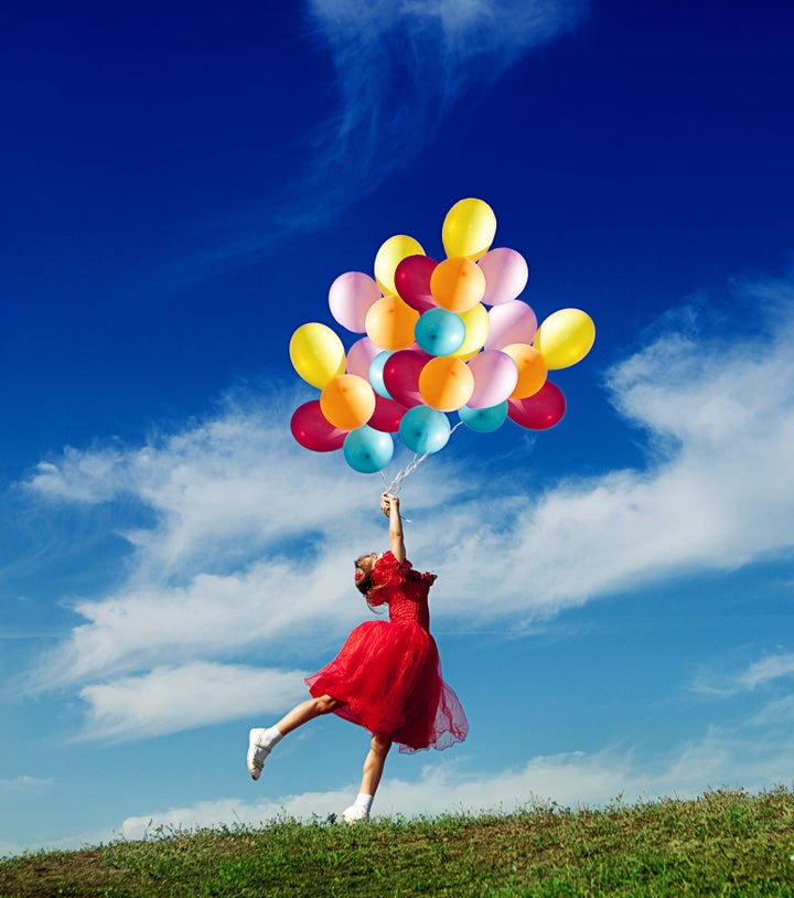 Little girl playing with balloons