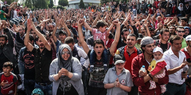 ISTANBUL, TURKEY - SEPTEMBER 16: (TURKEY OUT) Migrants and refugees demonstrate as Turkish police block the road at Esenler Bus Terminal on September 16, 2015 Istanbul, Turkey. Since the beginning of 2015 the number of migrants using the so-called 'Balkans route' has exploded with migrants arriving in Greece from Turkey and then travelling on through Macedonia and Serbia before entering the EU via Hungary. The number of people leaving their homes in war torn countries such as Syria, marks the largest migration of people since World War II. (Photo by Ahmet Sik/Getty Images)