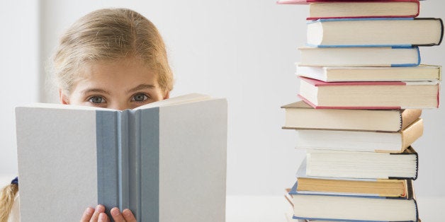 USA, New Jersey, Jersey City, Portrait of girl (8-9) reading book