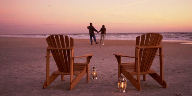 Rear view of a young couple walking on the beach