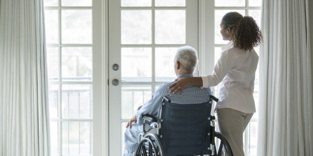 African American woman with Senior man in wheelchair