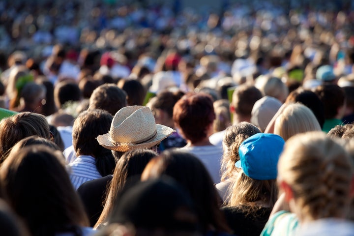 Large crowd of people watching concert or sport event