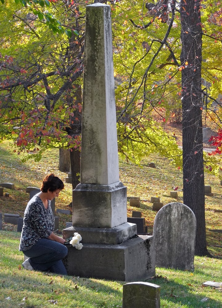 woman putting silk roses on...