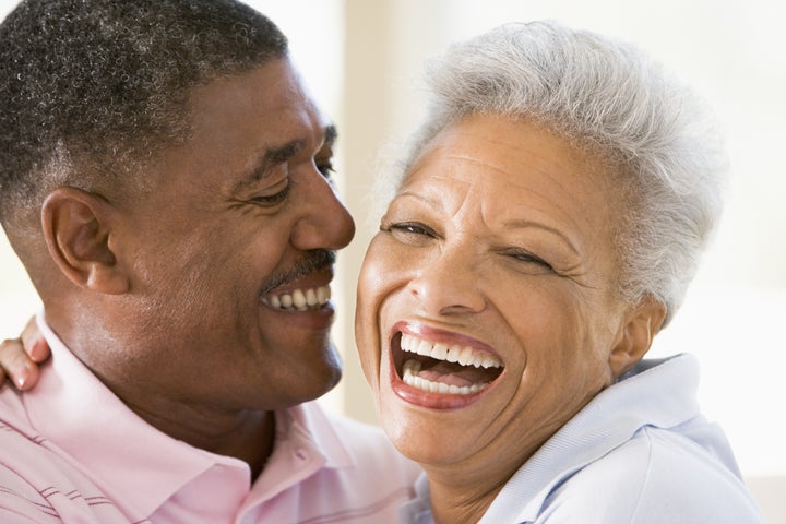 Couple relaxing indoors laughing