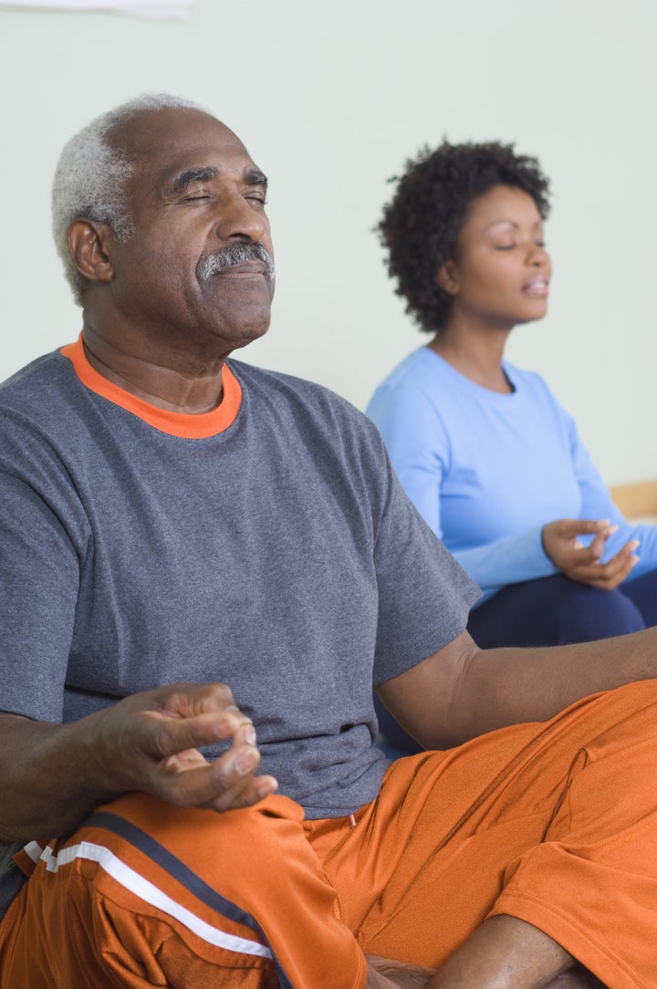 Senior man meditating in lotus position