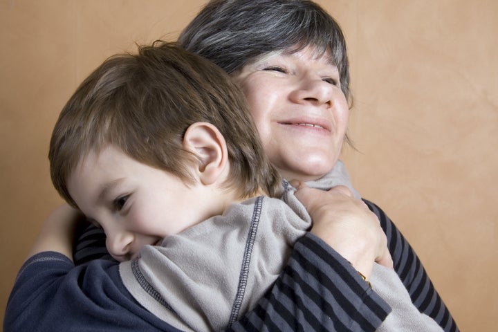 boy giving his grandmother a...