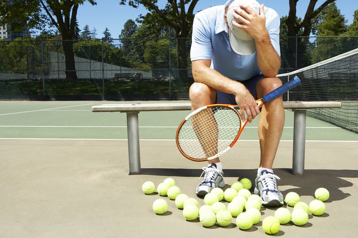 man holding a tennis racquet ...