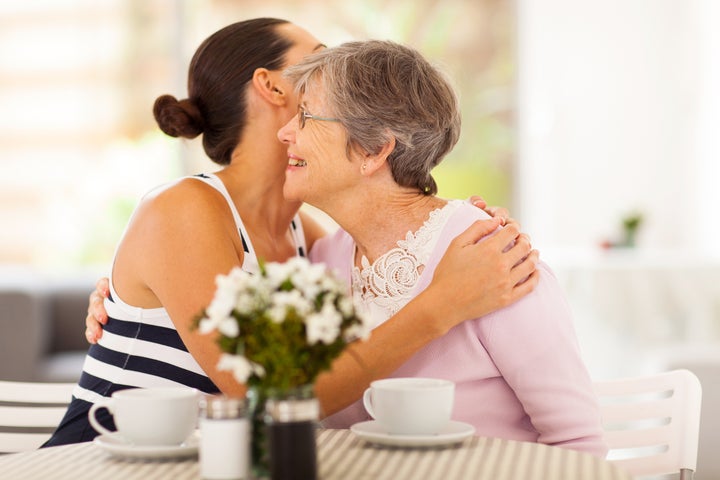 young woman hugging senior...