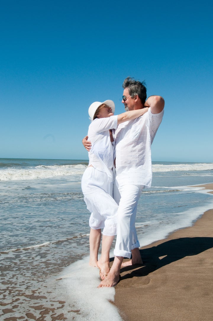 happy mature couple dancing at...