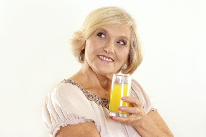 older woman with juice on the...