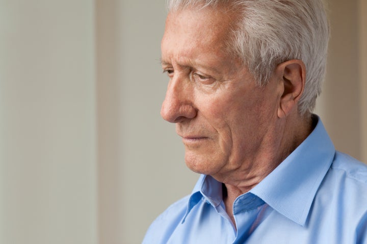 sad senior man looking down...