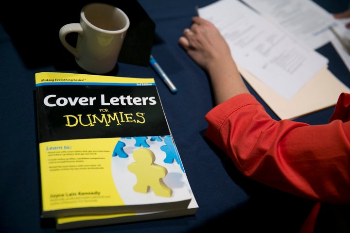 Sherry Mirshahi-Totten looks over a job seeker's resume at a National Career Fairs job fair in Arlington, Virginia, U.S., on