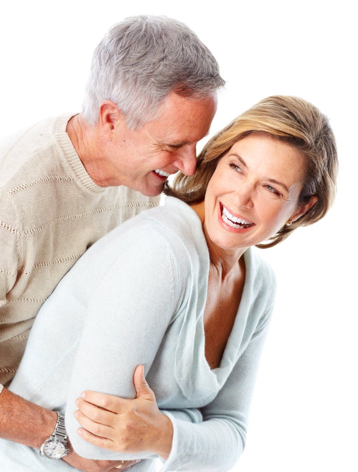 Happy seniors couple in love. Healthy teeth. Isolated over white background