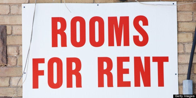 Rooms for rent sign on brick wall