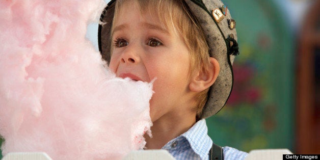 Boy (3-4 years) eating cotton candy