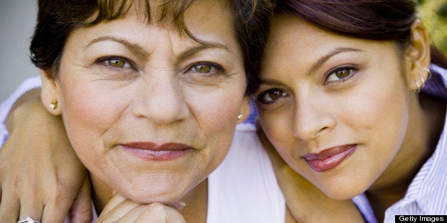 Daughter hugging mother, smiling, close-up, portrait