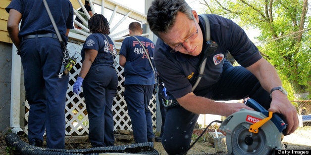 CAPITOL HEIGHTS, MD - APRIL 27: Lt. J.P.Callan uses an electric saw to cut lattice for the front porch of the Lowman family home, getting volunteer help to accommodate their 4 year old grandchild who is severely ill, as part of the annual 'Christmas in April' program on April, 27, 2013 in Capitol Heights, MD. (Photo by Bill O'Leary/The Washington Post via Getty Images)