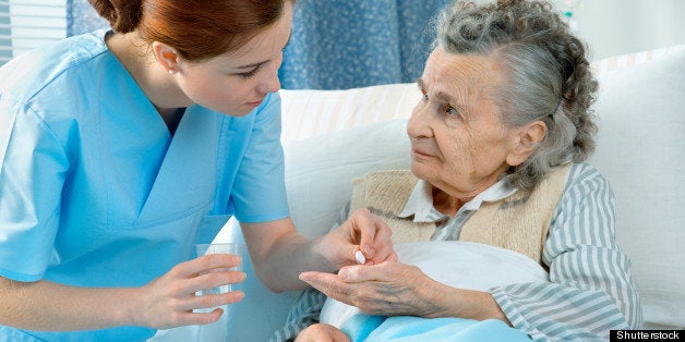 nurse cares for a elderly woman ...