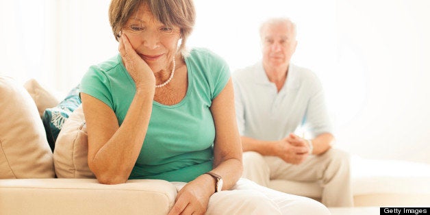 Senior woman upset while husband watches