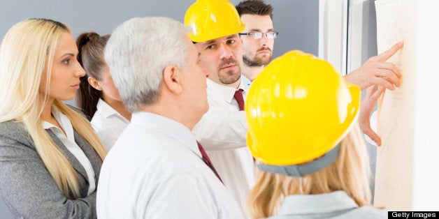 Business people discuss the project with colleagues and contractors.