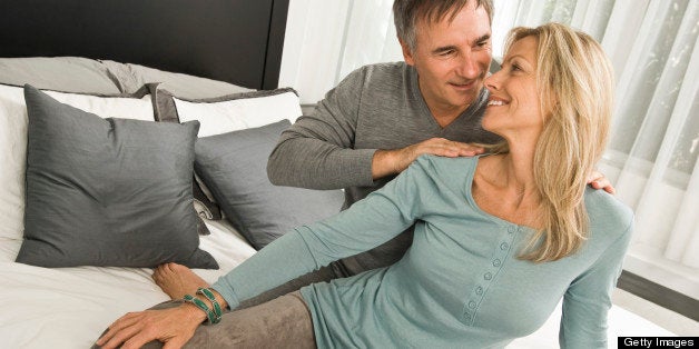 Couple romancing in a bedroom