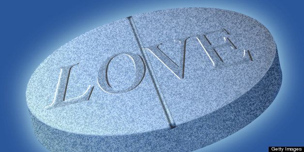 Conceptual illustration of a pill with the word 'love' on it.
