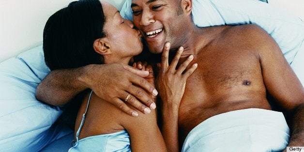 Overhead View of a Woman Kissing a Man in Bed