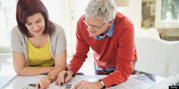 Mature couple discussing home designs in kitchen
