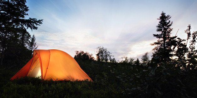 a tent lit up at dusk