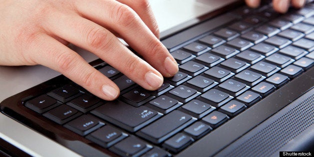 female hands typing on a laptop