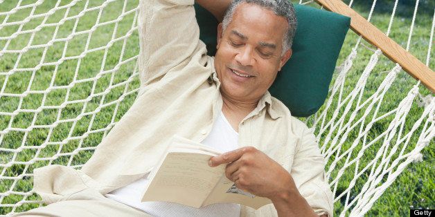 Older man reading on a hammock