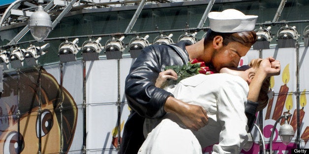 Hundres gather in Times Square to view the sculpture at the site of the historic LIFE Magazine cover photograph, of an unidentified sailor kissing nurse Edith Shain, by photographer Alfred Eisenstaedt August 14, 2010 in New York. The sculpture is commemorating the 65th anniversary of what Americans call V-J Day, marking the victory over Japan that ended the war in 1945. AFP PHOTO / DON EMMERT (Photo credit should read DON EMMERT/AFP/Getty Images)