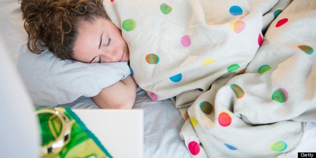 Teenage girl sleeping in bed