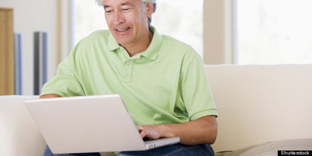 man in living room with laptop...