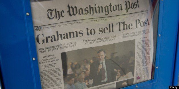The front page of the Washington Post newspaper as seen in a newstand, August 6, 2013 in Washington, DC, the day after it was announced that Amazon.com founder and CEO Jeff Bezos had agreed to purchase the newspaper for USD 250 million from the Graham family. Multi-billionaire Bezos, who created Amazon, which has soared in a few years to a dominant position in online retailing, said he was buying the Post in his personal capacity and hoped to shepherd it through the evolution away from traditional newsprint. AFP PHOTO / Saul LOEB (Photo credit should read SAUL LOEB/AFP/Getty Images)