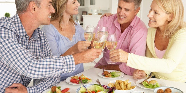 mid age couples enjoying meal...